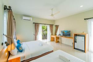 Postel nebo postele na pokoji v ubytování Lightplus Khao Lak