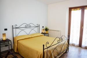 a bedroom with a large bed with a yellow bedspread at Villa Marianna in Vasto