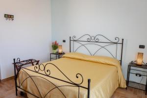a bedroom with a large bed with a yellow blanket at Villa Marianna in Vasto
