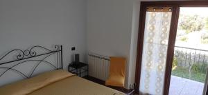 a bedroom with a bed and a window with a balcony at Villa Marianna in Vasto