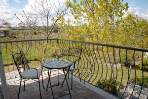 a patio with two chairs and a table on a balcony at Villa Marianna in Vasto