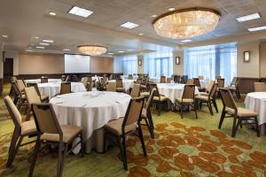 a conference room with tables and chairs and a podium at The Westin San Francisco Airport in Millbrae