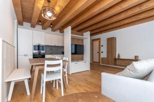 a kitchen and dining room with a table and chairs at Villa Caterina in Falcade