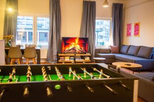 a living room with a pool table and a fireplace at 120qm/ City Loft/ Tischkicker in Hamburg