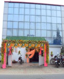 a building with a garland of flowers in front of it at Hotel Maurya Vihar Bodhgaya in Bodh Gaya