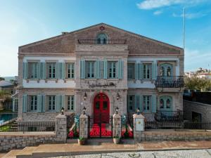a large brick house with a red door at Naz Su Cunda in Cunda