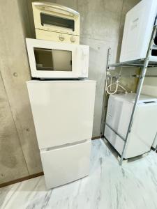 Η κουζίνα ή μικρή κουζίνα στο ストレッチ西落合104