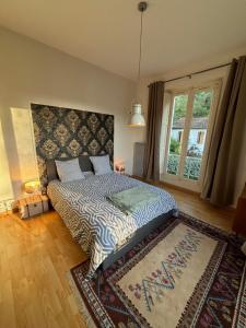 um quarto com uma cama com um tapete e uma janela em ALINE GRAND HOTEL em Capvern