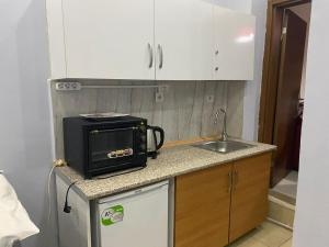 a small kitchen with a microwave and a sink at 5 kişilik 2 odalı stüdyo daire in Istanbul