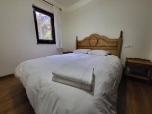 a large white bed in a bedroom with a window at Piso Acogedor en La Molina in La Molina