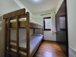 a bedroom with two bunk beds and a window at Piso Acogedor en La Molina in La Molina