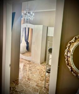 a dressing room with a mirror and a chandelier at Il Castello Di Venere in Rota d'Imagna