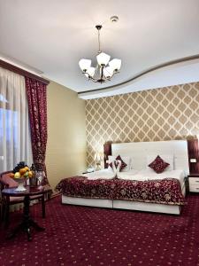 a large bedroom with a large bed and a table at Armenian Royal Palace in Yerevan