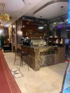 a bar in a restaurant with two chairs and a counter at الفخامة الجنوبية للشقق المخدومة in Jazan