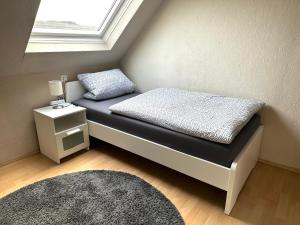 een klein bed in een kamer met een raam bij Ferienwohnung in Ettinghausen 
