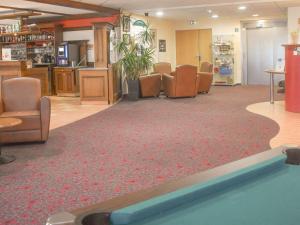 a waiting room with chairs and a pool at ibis Albert Pays de Somme in Albert