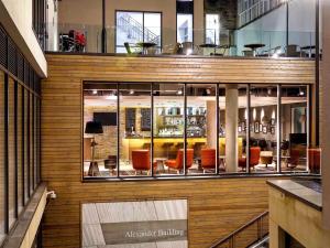 an apartment building with a lobby with chairs at ibis Edinburgh Centre South Bridge – Royal Mile in Edinburgh