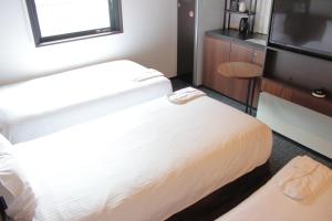 Cama o camas de una habitación en Henn na Hotel Tokyo Akasaka