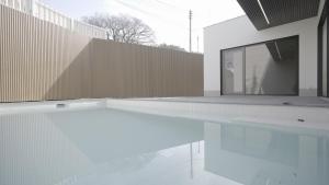 a house with a swimming pool and a wooden fence at Byeonsan Stay 365 in Buan