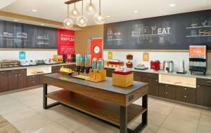 a kitchen with a table in a restaurant at Hampton Inn & Suites Fultondale Birmingham I 65, Al in Fultondale