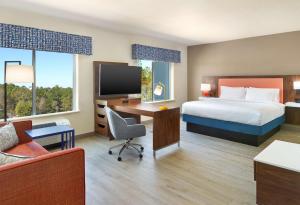 a hotel room with a bed and a desk with a computer at Hampton Inn & Suites Fultondale Birmingham I 65, Al in Fultondale