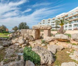 a rock garden in front of a building at DoubleTree by Hilton Malta in St Paul's Bay