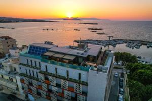 an aerial view of a building with the sunset in the background at Chania Flair Boutique Hotel, Tapestry Collection by Hilton in Chania Town