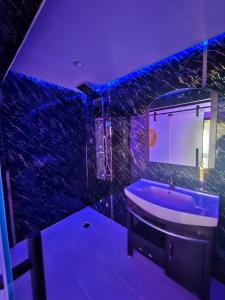 a purple bathroom with a tub and a sink at Sky2030Group in Dammam