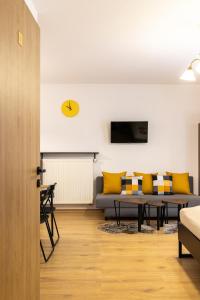 a living room with a couch and a table at Molonówka Guest House in Szczyrk