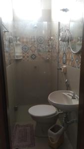 a bathroom with a toilet and a sink at Hotel Vitoria Andradina in Andradina +25 photos