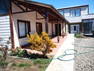 a house with a hose on the side of it at Freedom Ame 3 in Río Gallegos