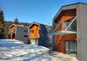 a house in the winter with snow on the ground at A2 Apartment & Studio in Ružomberok