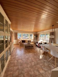 una gran sala de estar con techo de madera. en Mountain Horizon, en Schwarzsee