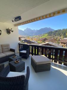 uma sala de estar com sofás e uma varanda com vista em Mountain Horizon em Schwarzsee
