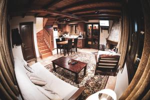 a living room with a white couch and a table at Mont Valley Boutique Chalets in Arachova