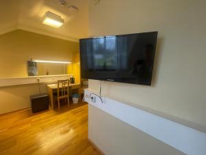 a large flat screen tv on a wall in a room at Motell Stella in Tranemo