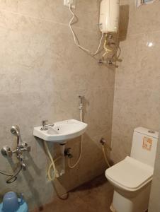 a bathroom with a sink and a toilet at HOTEL NEW MN GRAND in Hyderabad