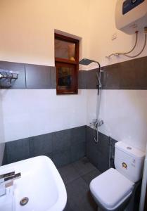 a bathroom with a white toilet and a sink at Maharagama 5BR bungalow 1BR USD 21 per night in Maharagama