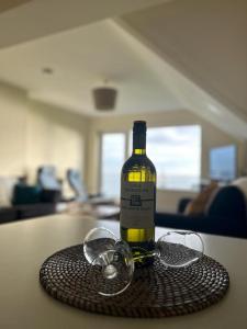 a bottle of wine and glasses on a table at Dunmore East Holiday and Golf Resort Apartments in Dunmore East