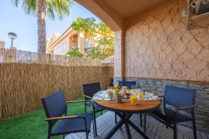 a patio with a table and chairs and a fence at Chill-out # Piscina todo el año # Playa a 650m in Vera