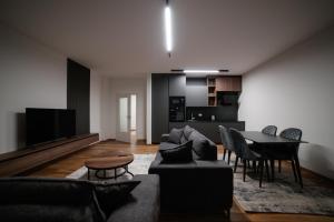 a living room with a couch and a table at Emery Apartments in Pristina