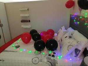 a group of balloons on a bed with christmas lights at 15 uvongo square holiday home in Margate