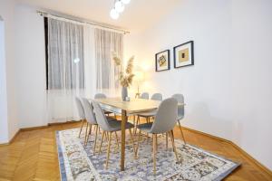 a dining room with a table and chairs at Caragiale Apartment in Bucharest