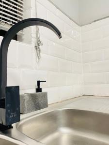 a sink with a faucet in a kitchen at Pelican Apartment in Durban
