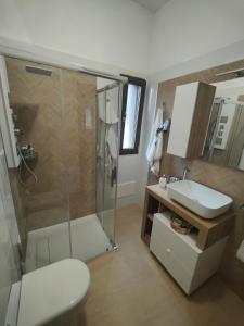 a bathroom with a shower and a toilet and a sink at Villa Raffaella in Lecce