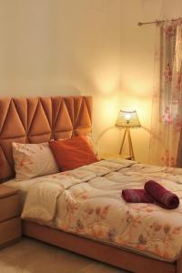 a bed with two pillows on it in a bedroom at Take a cosy rest Near the airport in Nouaceur