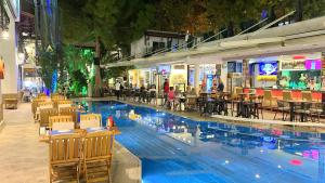 a swimming pool with chairs and tables in a mall at Istankoy Hotel in Bodrum City
