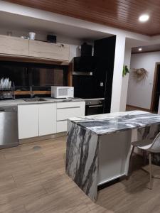 - une cuisine avec un comptoir en marbre dans l'établissement Passadiços do paiva house, à Cinfães