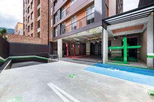 a building with a swimming pool in front of it at Cabrera 85 Apartments in Bogotá