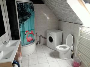 een badkamer met een toilet en een douchegordijn bij l'arche de noé 